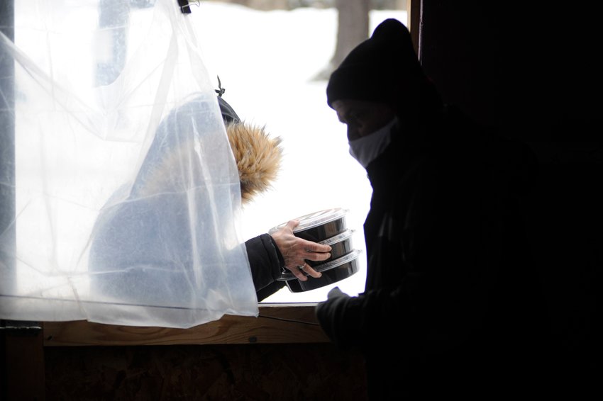 A person picks up food this past winter at the Sullivan County Federation for the Homeless. The federation gets its food from the Regional Food Bank.